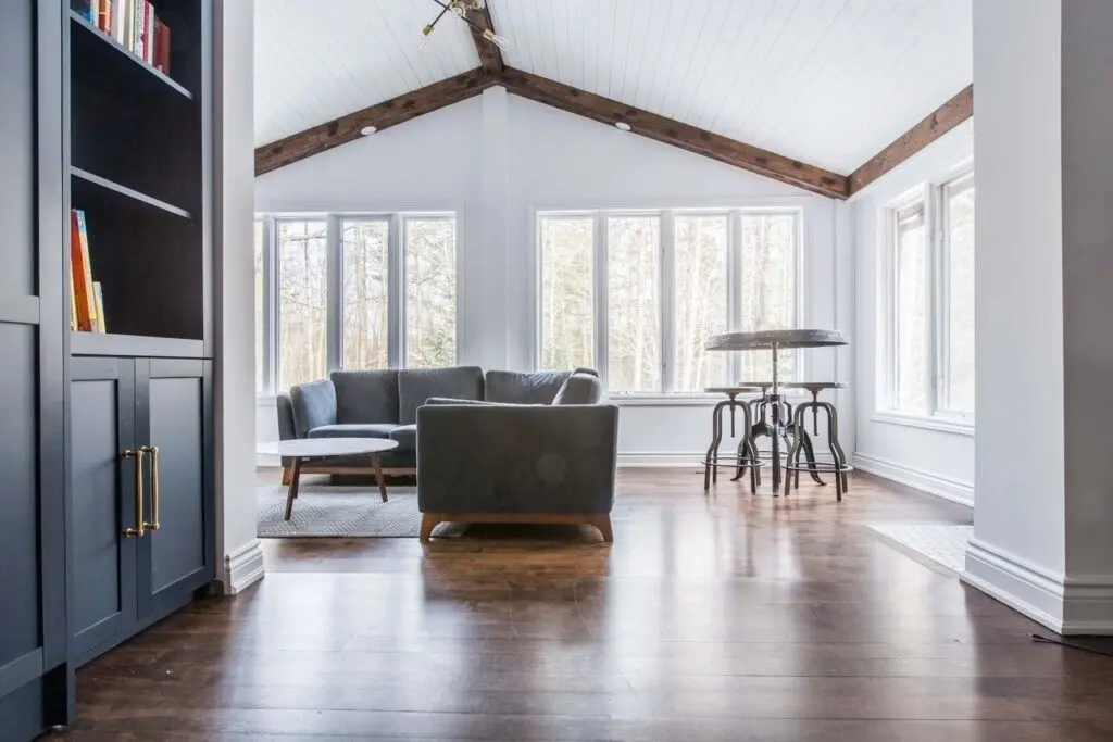 A living room with hard wood floors and vaulted ceilings.