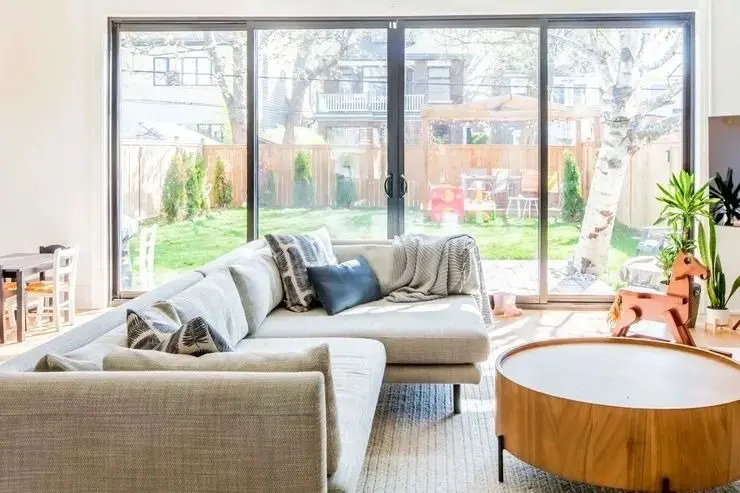 A living room with large windows and couches