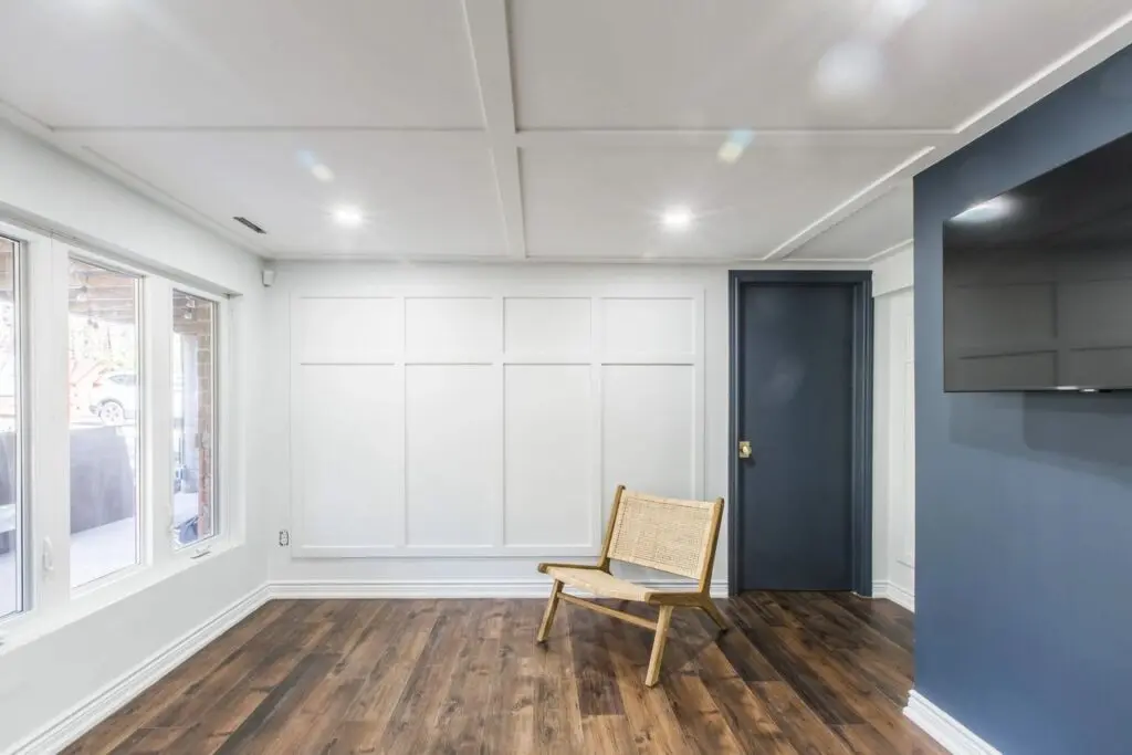 A room with wood floors and white walls.