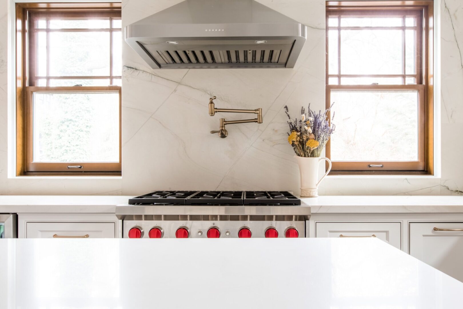 A kitchen with a stove and window in it